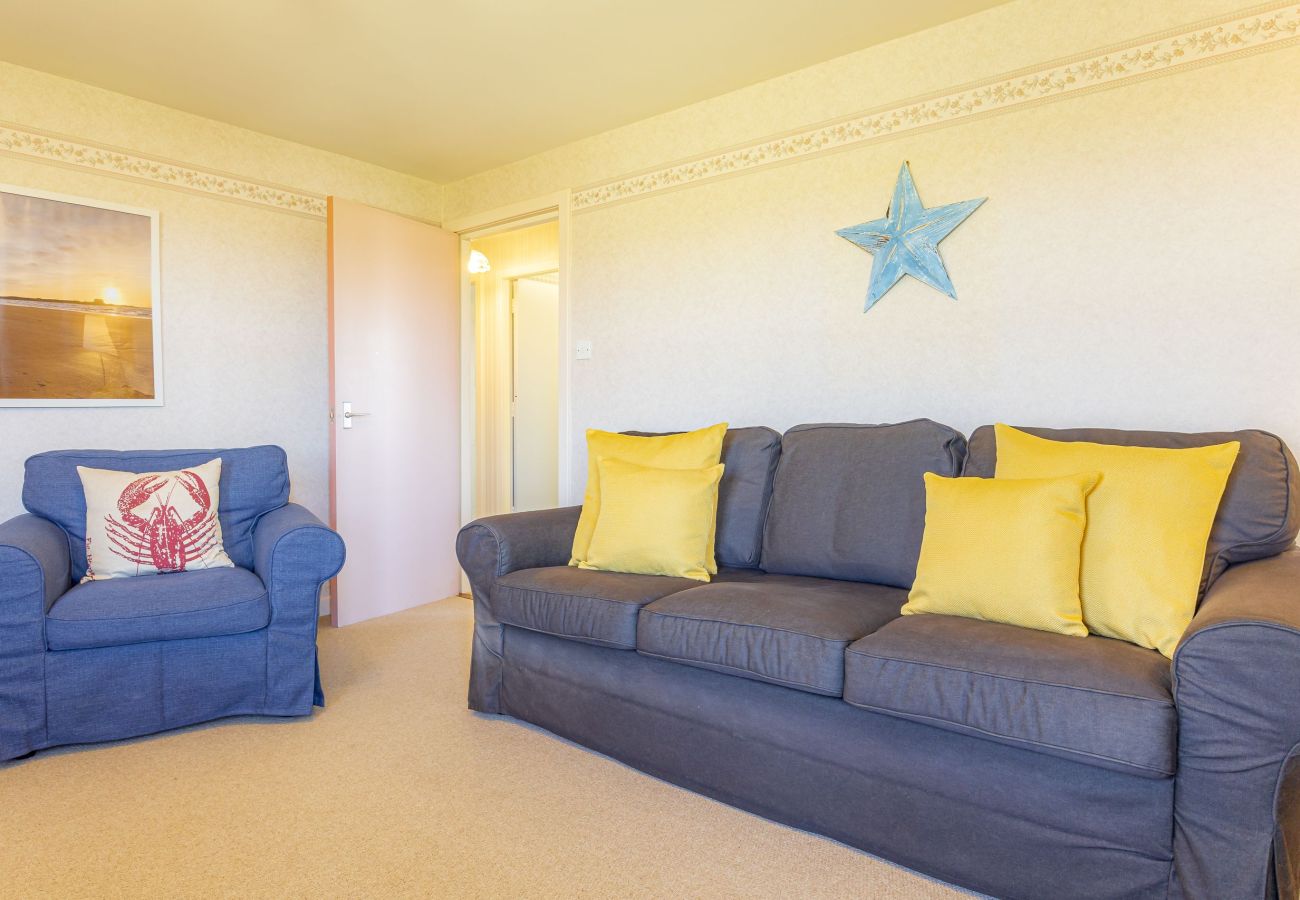 Inviting living room featuring a comfortable sofa with plush cushions and a matching chair