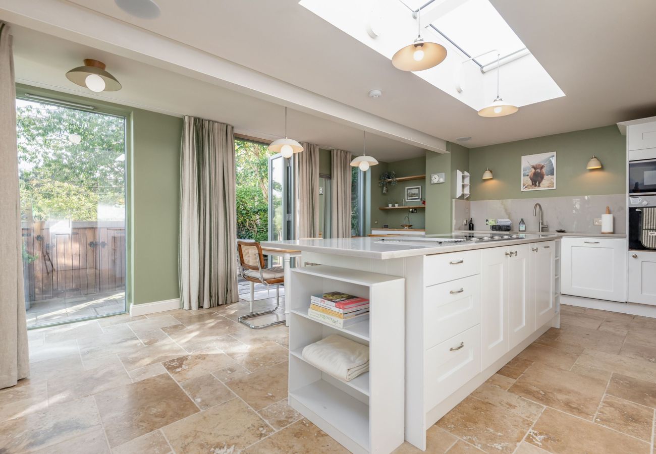 Open-plan kitchen with skylights, island unit and garden views in St Andrews holiday home.