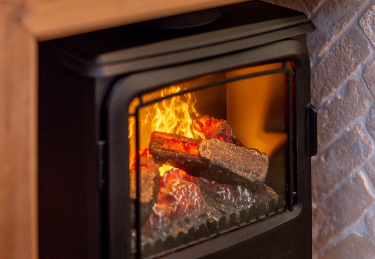 Close-up of glowing log-burner fire in cosy lounge at 42 Lade Braes, St Andrews holiday cottage.